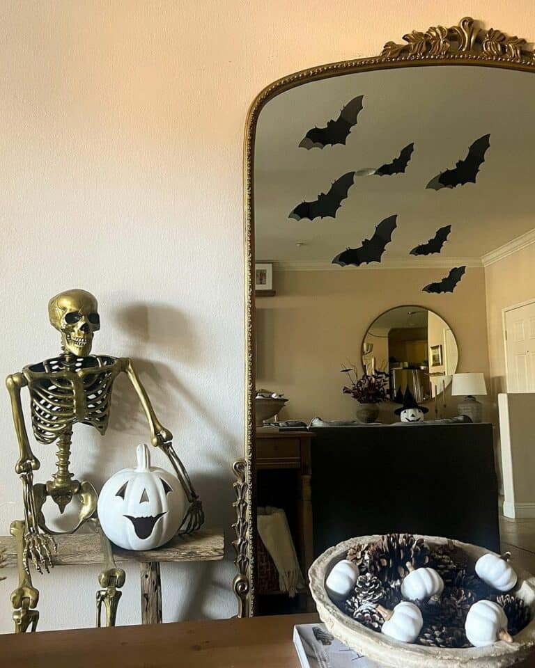 Brass Mirror and Skeleton Decor